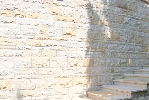 Geschwungene Mauer aus Kemu mit Treppe